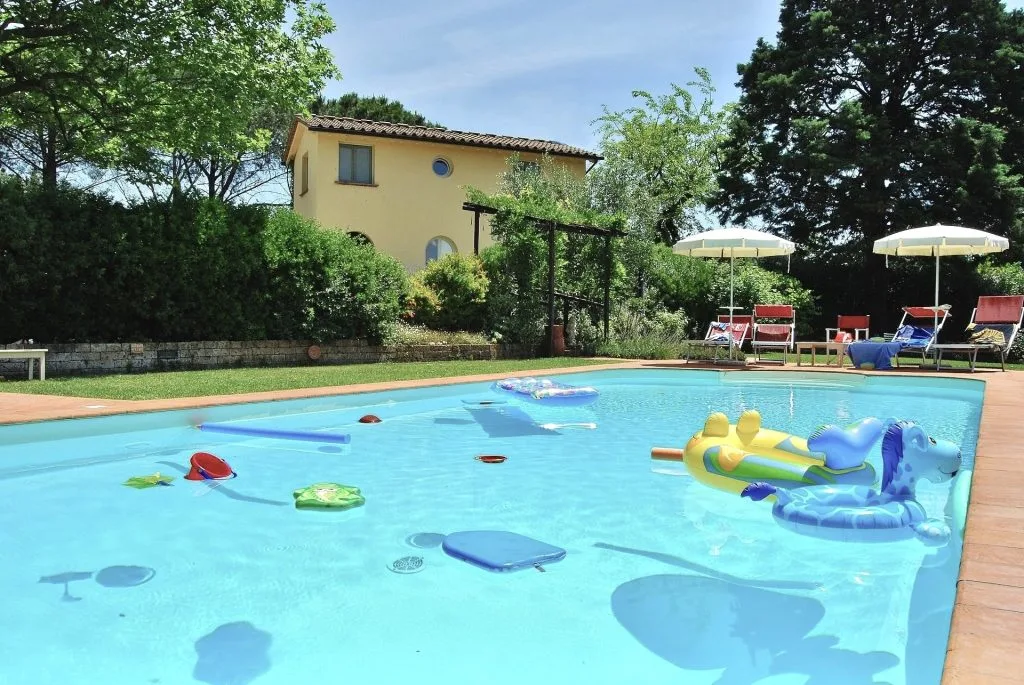 Private swimming pool next to the apartments surrounded by a beautiful garden
